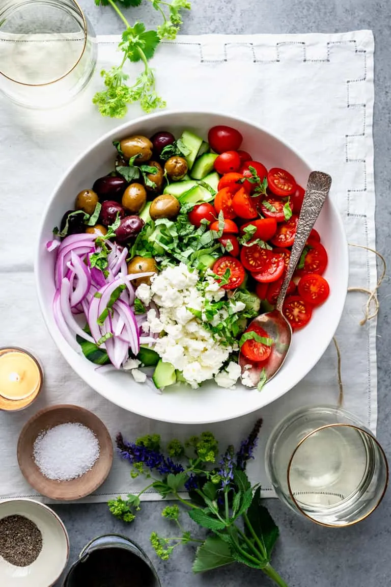Greek salad bowl with cucumber, tomato, olives, and feta